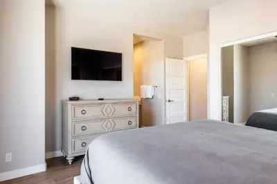 a bedroom with a bed and a dresser with a television at Snowcreek V 972 in Mammoth Lakes