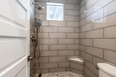 a bathroom with a shower with a toilet and a window at Snowcreek V 972 in Mammoth Lakes