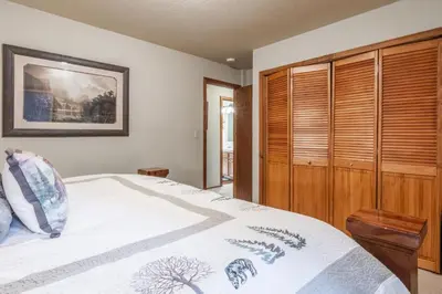 a bedroom with a bed and a wooden cabinet at North Shore - Pinetree Paradise in Tahoe Vista