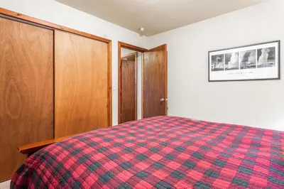 a bedroom with a bed and wooden cabinets at North Shore - Pinetree Paradise in Tahoe Vista
