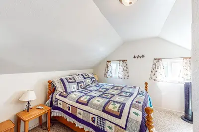 a bedroom with a bed in a attic at Pine Needle Nook in Kings Beach