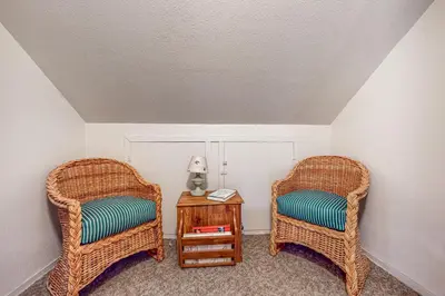 two wicker chairs and a table in a room at Pine Needle Nook in Kings Beach