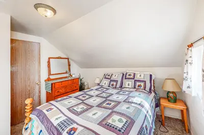 a bedroom with a bed and a dresser and a mirror at Pine Needle Nook in Kings Beach