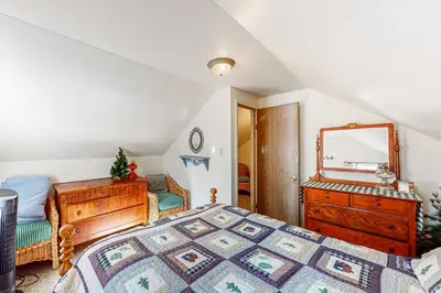 a bedroom with a bed and a dresser and a mirror at Pine Needle Nook in Kings Beach