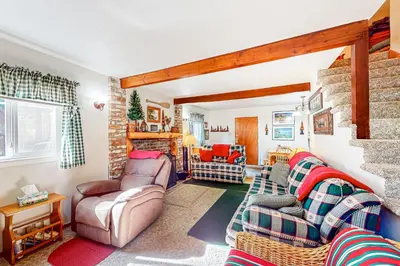 a living room with two couches and a fireplace at Pine Needle Nook in Kings Beach