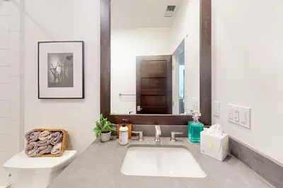 a bathroom with a sink and a toilet and a mirror at Creekhouse 1362 in Mammoth Lakes