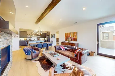a living room with two couches and a table at Creekhouse 1362 in Mammoth Lakes
