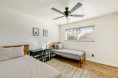 a bedroom with two beds and a ceiling fan at Visalia Vacation Rental with Yard 1 Mi to Downtown in Visalia