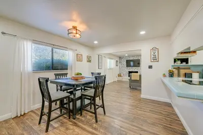 a dining room and kitchen with a table and chairs at Visalia Vacation Rental with Yard 1 Mi to Downtown in Visalia