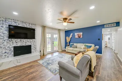 a living room with a fireplace and a tv at Visalia Vacation Rental with Yard 1 Mi to Downtown in Visalia