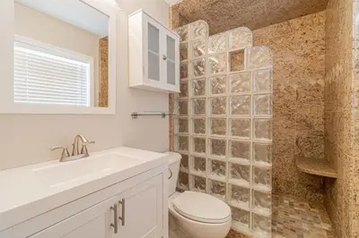 a white bathroom with a toilet and a sink at Vibrant Boho Home 3 Bed Pet Friendly in Reno