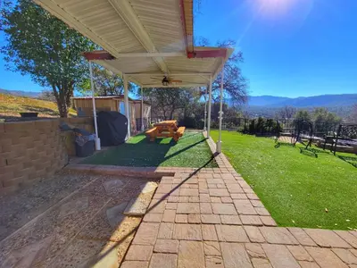 a pavilion with a picnic table in a yard at Yosemite Gateway Cottage - King Suite - Mountain Views in Oakhurst