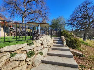 a set of stone stairs leading to a house at Yosemite Gateway Cottage - King Suite - Mountain Views in Oakhurst
