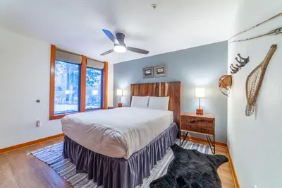 a bedroom with a bed and a ceiling fan at Luxurious Remodeled Village Oasis in Mammoth Lakes