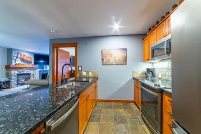 a kitchen with granite counter tops and a sink at Luxurious Remodeled Village Oasis in Mammoth Lakes