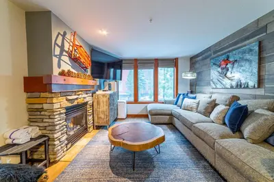 a living room with a couch and a fireplace at Luxurious Remodeled Village Oasis in Mammoth Lakes