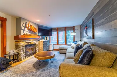 a living room with a couch and a fireplace at Luxurious Remodeled Village Oasis in Mammoth Lakes