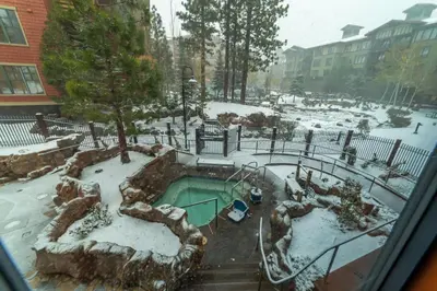a garden covered in snow with a pool at Luxurious Remodeled Village Oasis in Mammoth Lakes