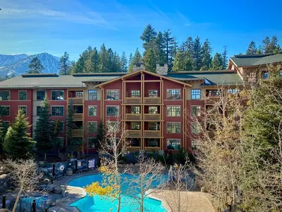 an exterior view of a resort with a swimming pool at Quiet, Updated, Corner Condo in the Village! Parking, Pool & Spa in Mammoth Lakes