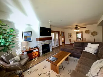 a living room with a couch and a fireplace at Quiet, Updated, Corner Condo in the Village! Parking, Pool & Spa in Mammoth Lakes