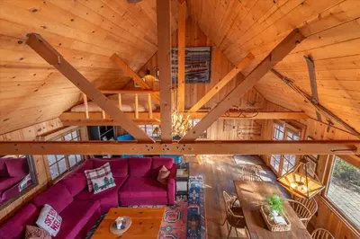 an overhead view of a living room in a log cabin at Coziest Cabin in Tahoe w Stone Fireplace Comfy Beds Close to Slopes & Lake in Carnelian Bay