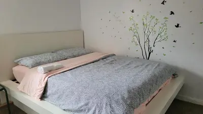 a bedroom with a bed with butterflies on the wall at Yosemite International Hostel in Groveland