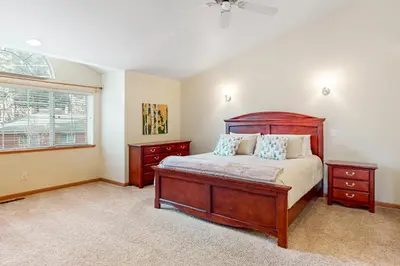 a bedroom with a bed and two dressers and a window at High Meadow Hideaway in South Lake Tahoe