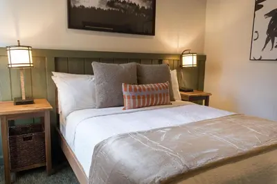 a bedroom with a large bed with two lamps at Firefall Ranch Yosemite in Groveland