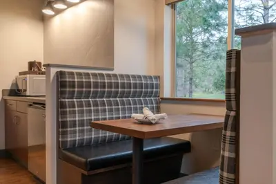 a kitchen with a bench and a table and a window at Firefall Ranch Yosemite in Groveland