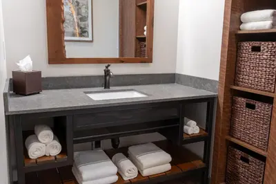 a bathroom with a sink and a mirror and towels at Firefall Ranch Yosemite in Groveland