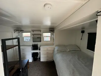 a bedroom with a bed and a desk in a trailer at Midtown Charm: 1BR Urban Pad in Reno