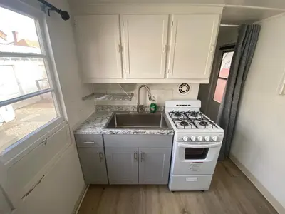 a small kitchen with a stove and a sink at Midtown Charm: 1BR Urban Pad in Reno