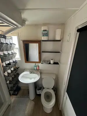 a small bathroom with a toilet and a sink at Midtown Charm: 1BR Urban Pad in Reno