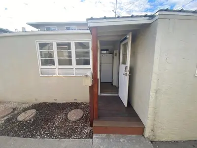 a door leading to a house with a porch at Midtown Charm: 1BR Urban Pad in Reno