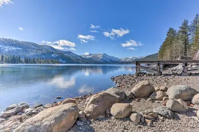a dock on a lake with mountains in the background at Modern Gambrel Cabin Near Ski Resorts in Truckee