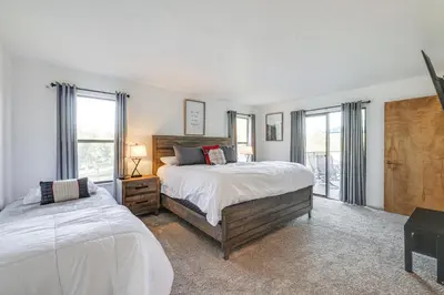 a bedroom with two beds and two windows at Groveland Home with Deck 2 Mi to Pine Mountain Lake in Groveland