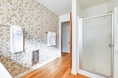 a bathroom with white towels hanging on a wall at Groveland Home with Deck 2 Mi to Pine Mountain Lake in Groveland