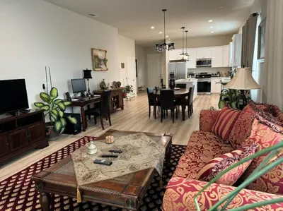 a living room with a couch and a table at Brand New South Sacramento Home in Sacramento