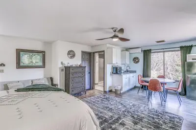 a bedroom with a bed and a table and a kitchen at Cozy Studio with Well-Being Retreat Near Yosemite! in Ahwahnee