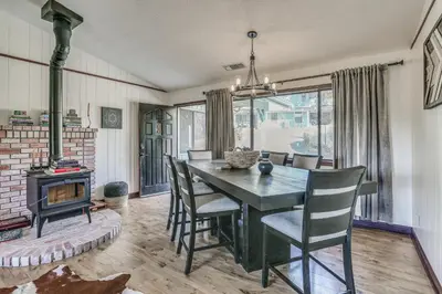a dining room with a table and chairs and a fireplace at Mountain Home Near Yosemite with Well-Being Retreat! in Ahwahnee