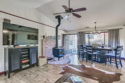 a living room with a stove and a dining room at Mountain Home Near Yosemite with Well-Being Retreat! in Ahwahnee