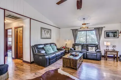 a living room with a leather couch and a table at Mountain Home Near Yosemite with Well-Being Retreat! in Ahwahnee