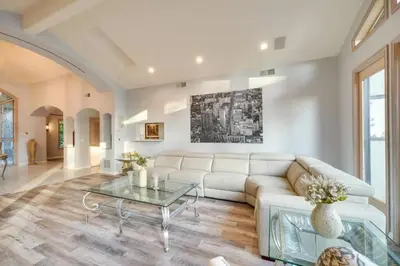a living room with a white couch and a table at Mansion, Pool, Game Room in Pollock Pines