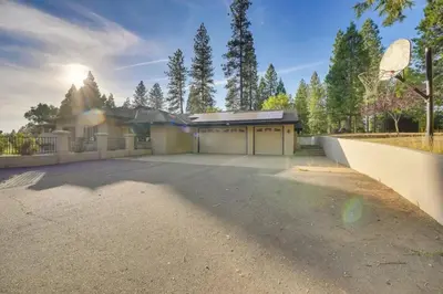 a house with a basketball hoop in front of a driveway at Mansion, Pool, Game Room in Pollock Pines