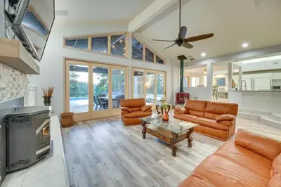 a living room with leather furniture and a fireplace at Mansion, Pool, Game Room in Pollock Pines