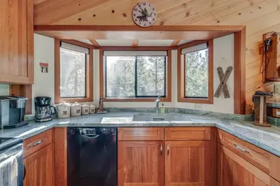 a kitchen with a sink and a clock on the wall at Home 1 Mi to Downhill Ski Resort Bring Your Pets! in Truckee