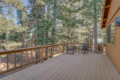 a wooden deck with a table and chairs on it at Home 1 Mi to Downhill Ski Resort Bring Your Pets! in Truckee