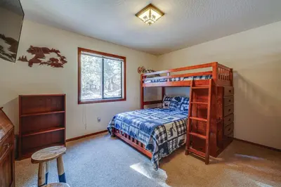 a bedroom with a bunk bed with a ladder at Home 1 Mi to Downhill Ski Resort Bring Your Pets! in Truckee