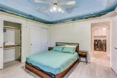 a bedroom with a bed and a blue ceiling at Billiards and Private Pool Bright Clovis Home! in Clovis