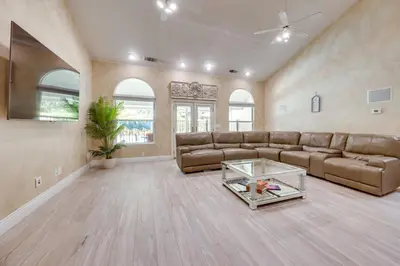 a large living room with a couch and a table at Billiards and Private Pool Bright Clovis Home! in Clovis
